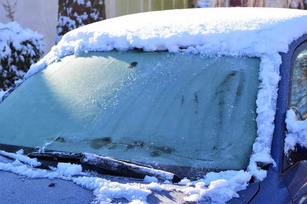 Iced snow on a car roof in the sunlight as a close-up